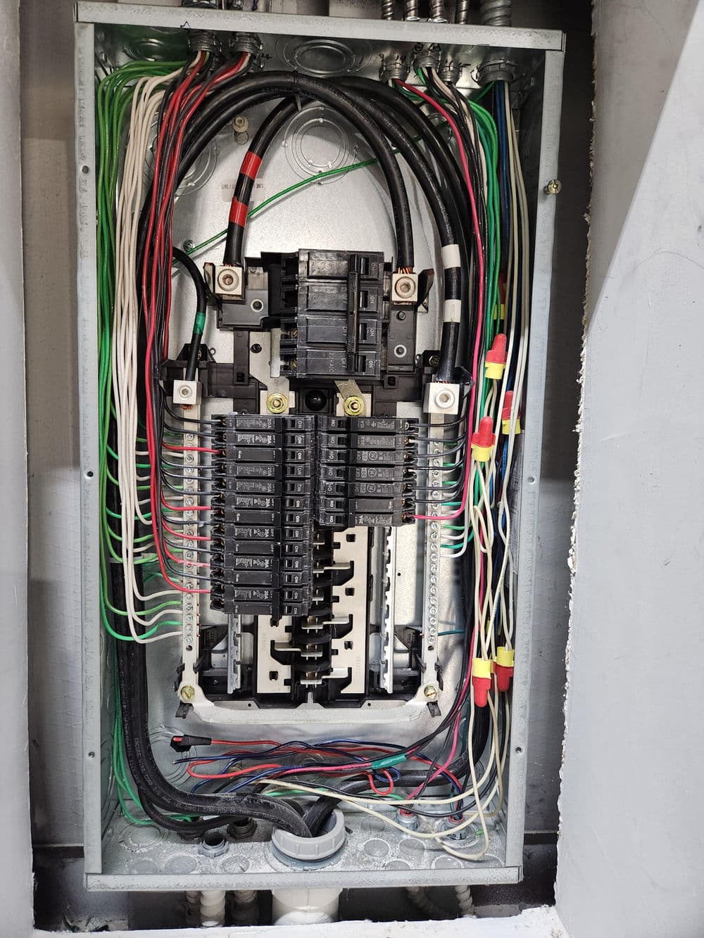 Electrical panel with circuit breakers and wiring, showcasing organized connections and infrastructure.
